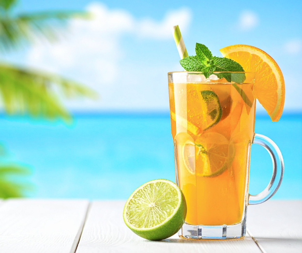 Summer detox water with orange, mint and lime in a glass