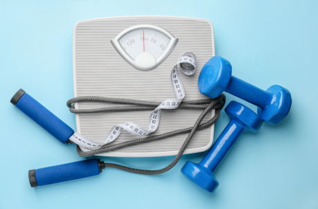 Weighing scale with dumbbells and skipping rope for weight loss