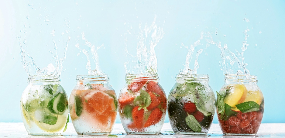 Jars of colorful fruit infused detox water
