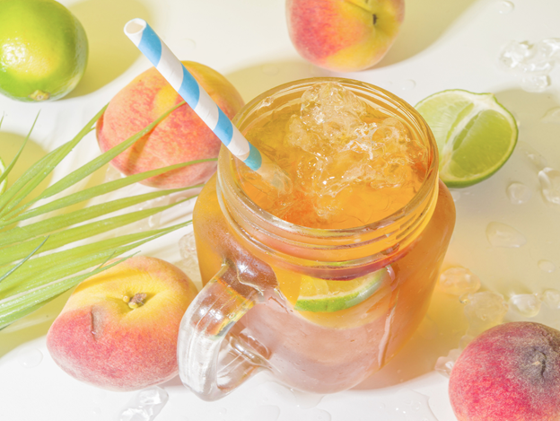 Homemade peach iced tea with fresh fruit and lime