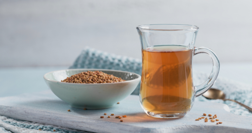Fenugreek methi seed tea in glass cup with seeds - fenugreek tea for weight loss