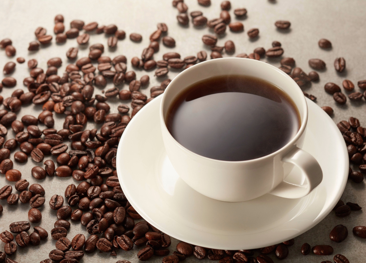 Cup of black coffee with coffee beans - black coffee for weight loss